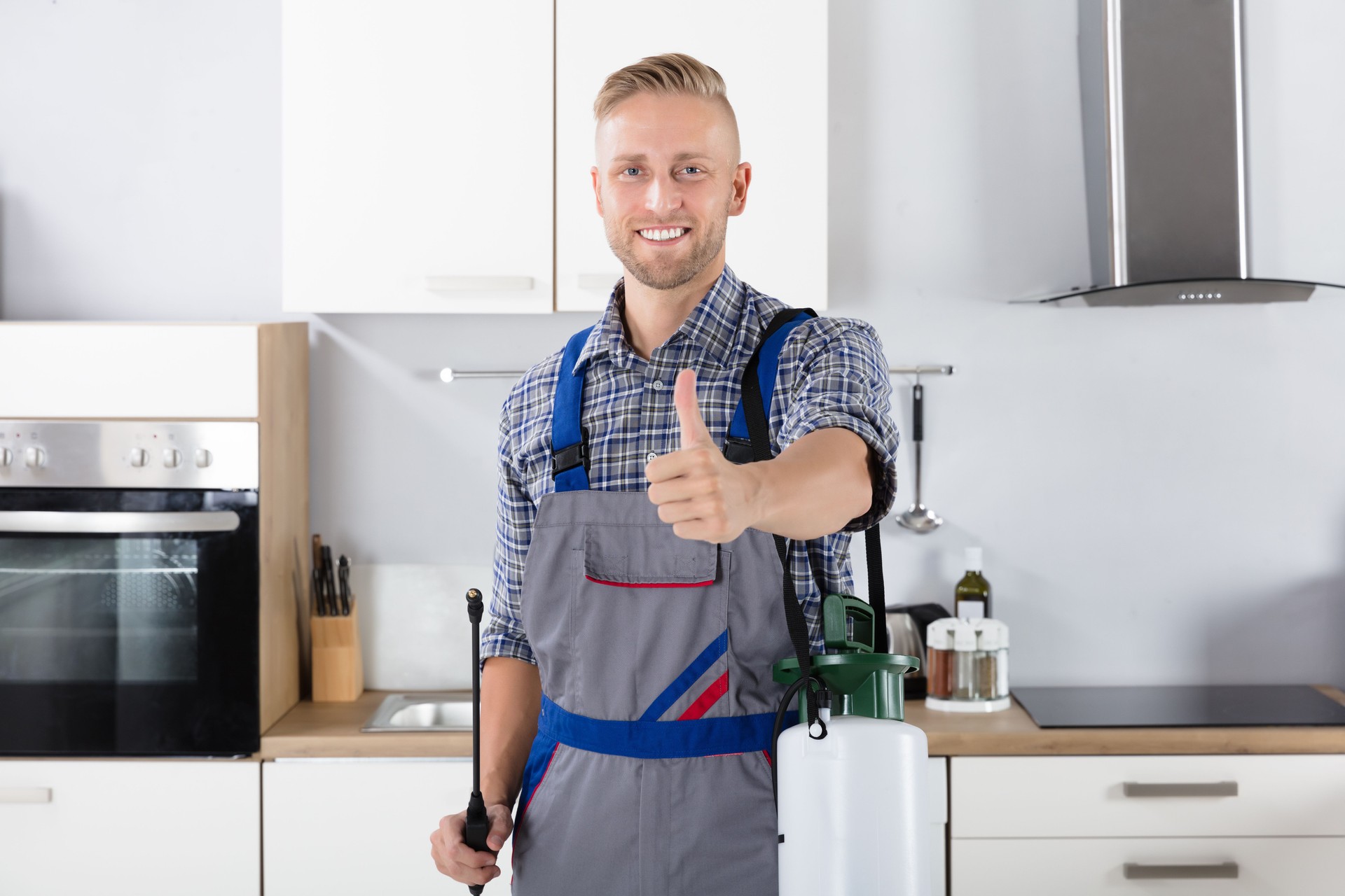 Confident Pest Control Worker With Pesticide Container